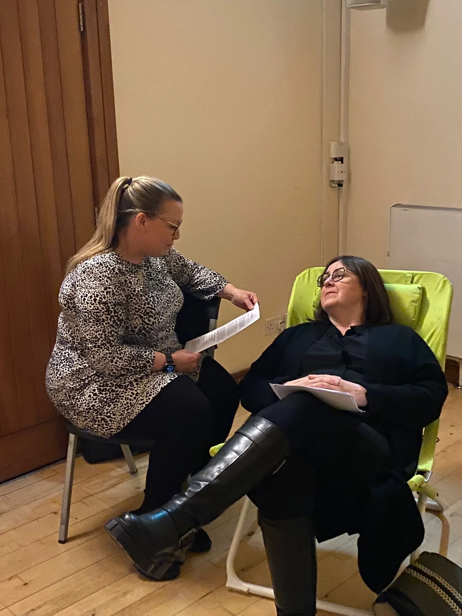 Two students practicing Hypnotherapy techniques at UK Therapy Guild training session.