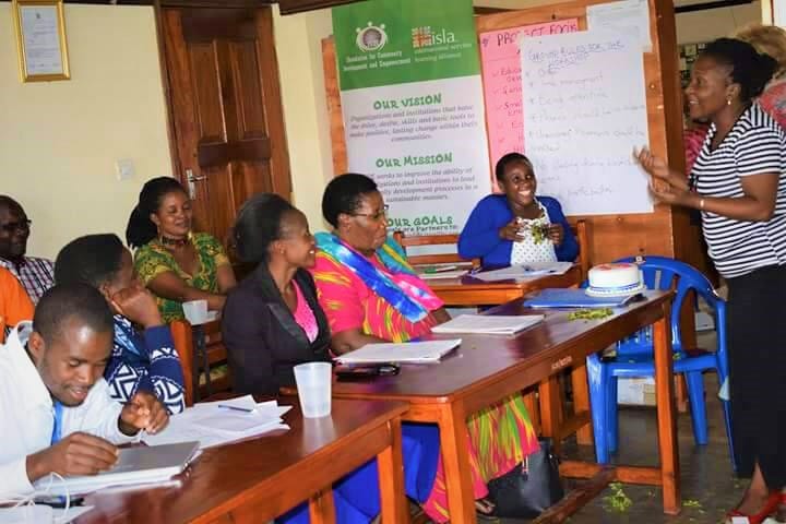 Group counselling training workshop in classroom with tutor presenting to engaged students, professional development course
