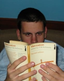 Student reading "Metrication, edited by F.W. Kellaway" — studying during counselling training session, Liverpool