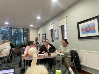 class mascot Sylvester looking over interactive group task uk therapy guild west derby millenium centre, Liverpool